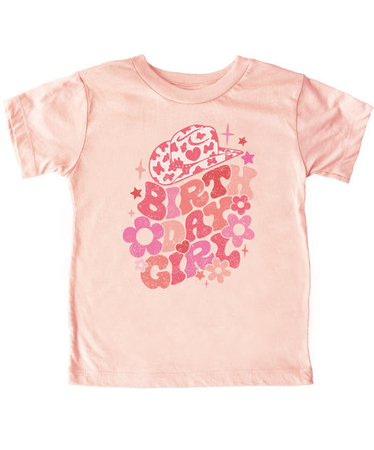 Close-up of groovy cowgirl birthday design on natural colored toddler tee