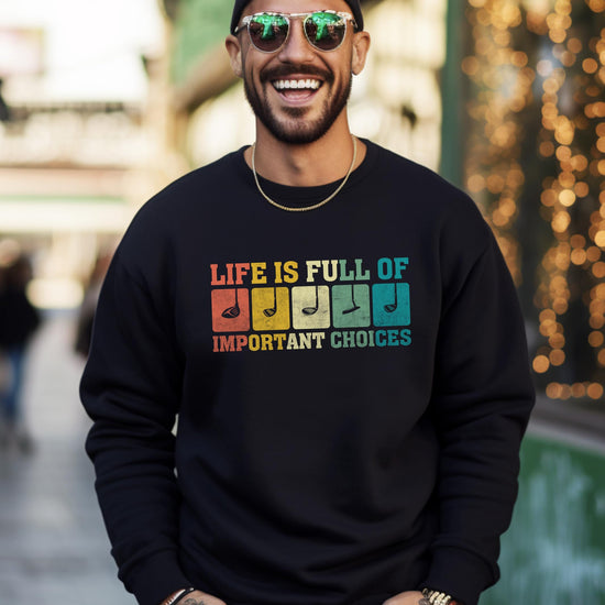 Close-up of bold golf club graphic print on black men's crewneck sweatshirt by Olive Loves Apple