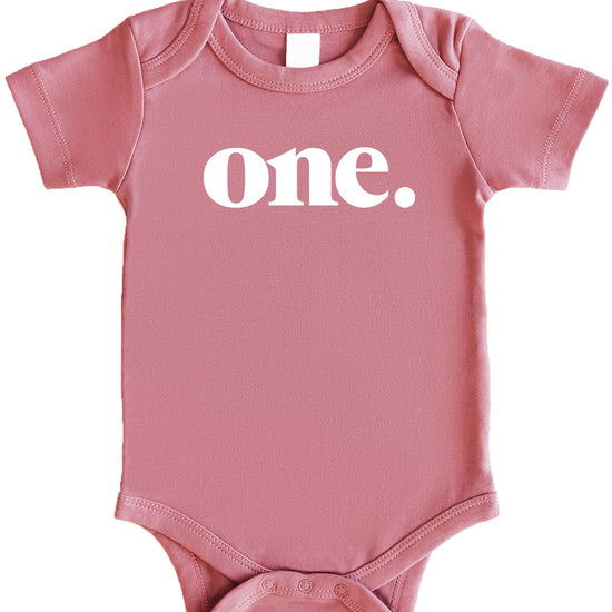 Bold One 1st birthday bodysuit in white on mauve for baby first birthday outfit by Olive Loves Apple