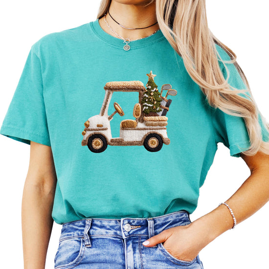 Close-up of ink-printed Christmas golf cart and holiday tree design on women's tee