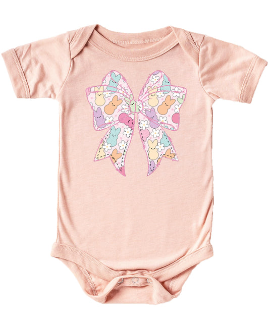 Close-up of Easter bunny and floral print on peach baby bodysuit