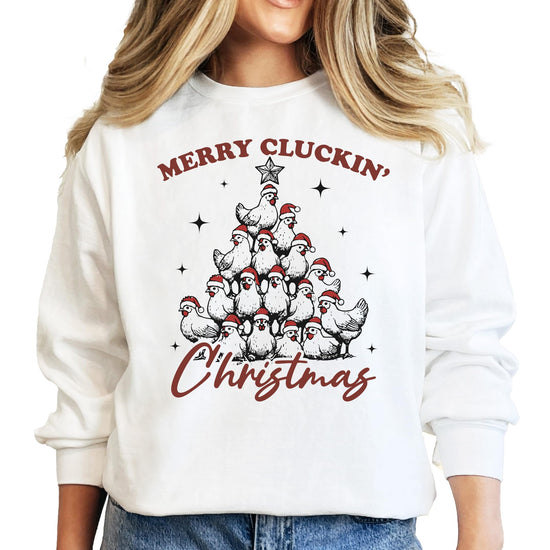 White women's pullover sweatshirt with a funny Merry Cluckin' Christmas chicken Santa hat Christmas tree graphic