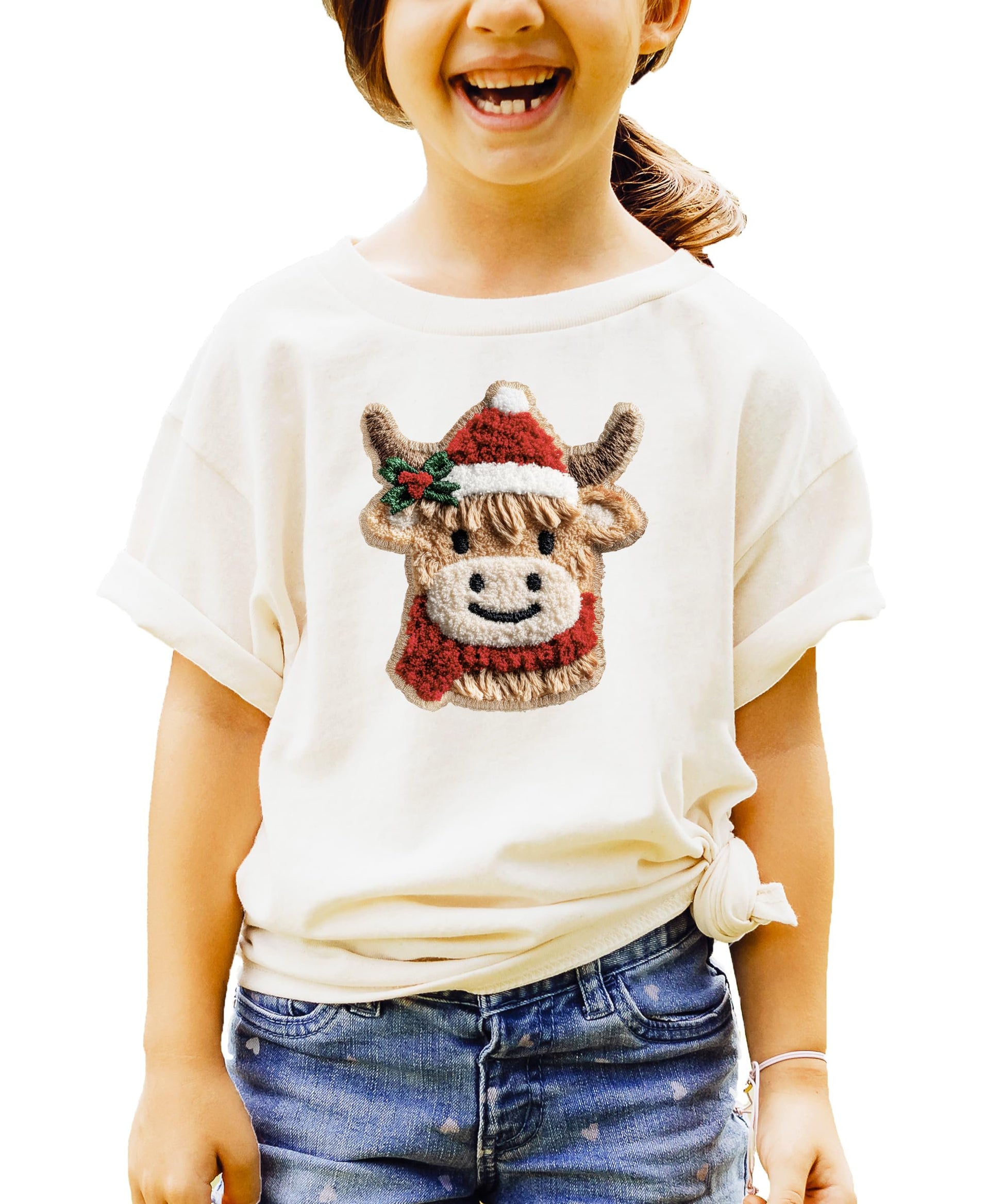 Close-up of ink-printed cow Christmas design on red youth graphic tee