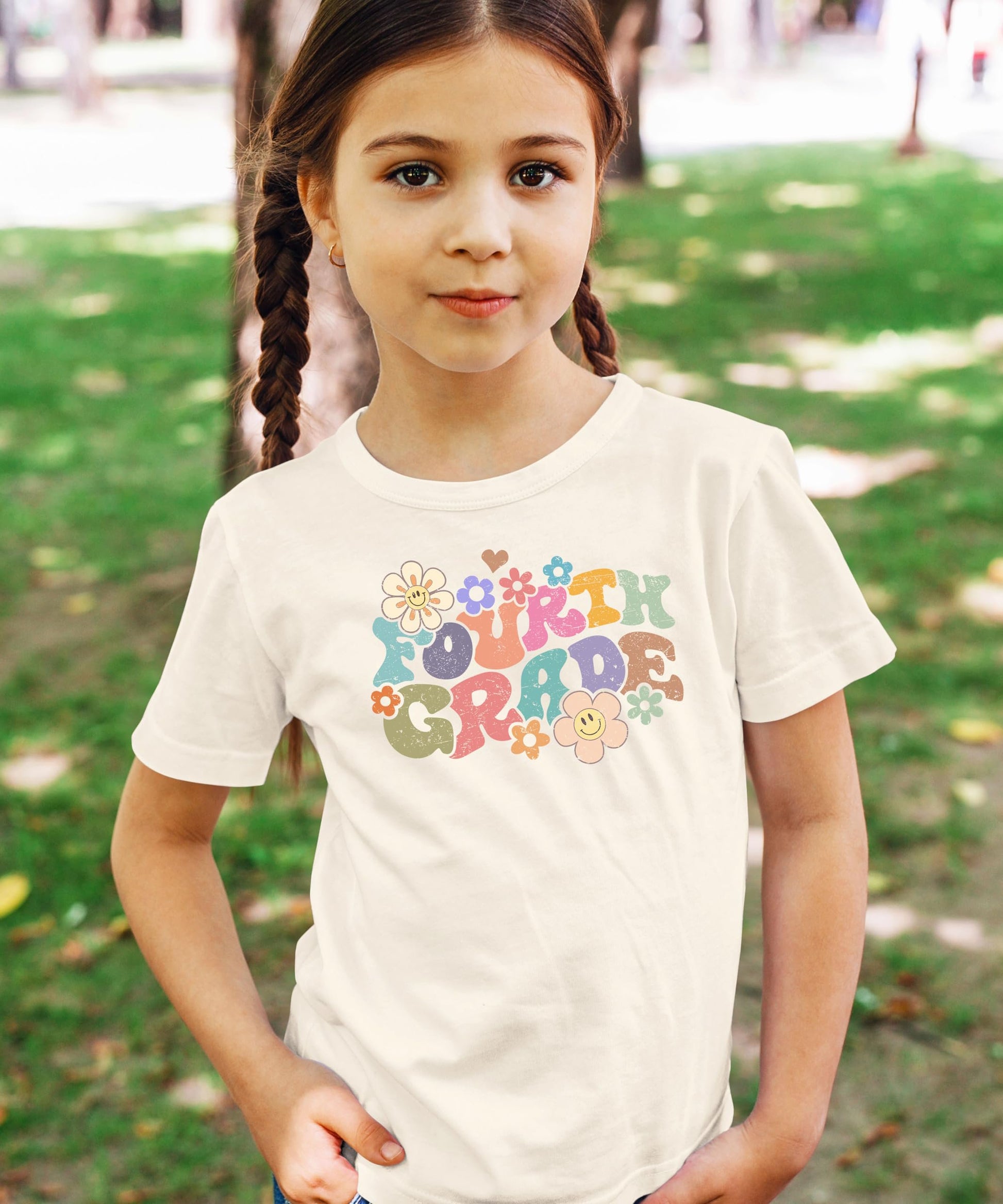 Flat lay of 4th grade groovy daisy first day of school t-shirt