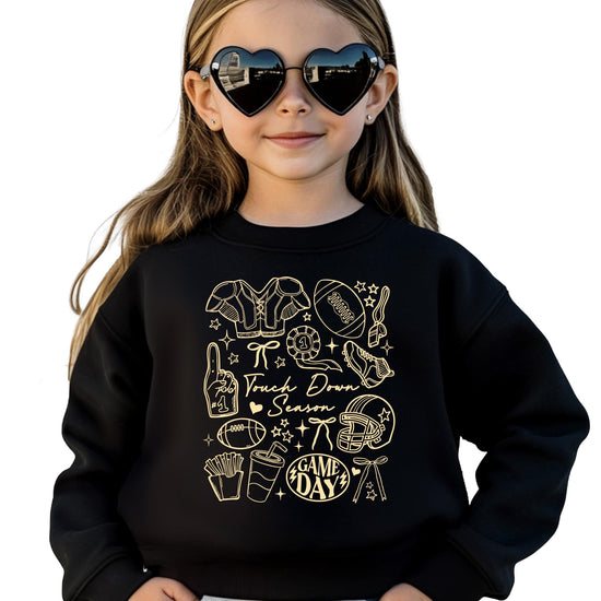 Detail shot of football themed graphics on Touch Down Season sweatshirt with sports equipment design