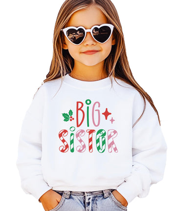 Kids white sweatshirt with candy cane stripe Big Sister lettering in red, green, and pink with holly and star accents