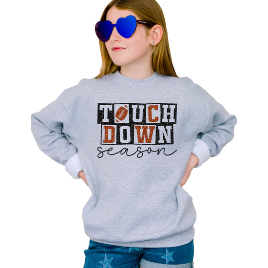 Detail shot of faux glitter football graphic on grey game day sweatshirt