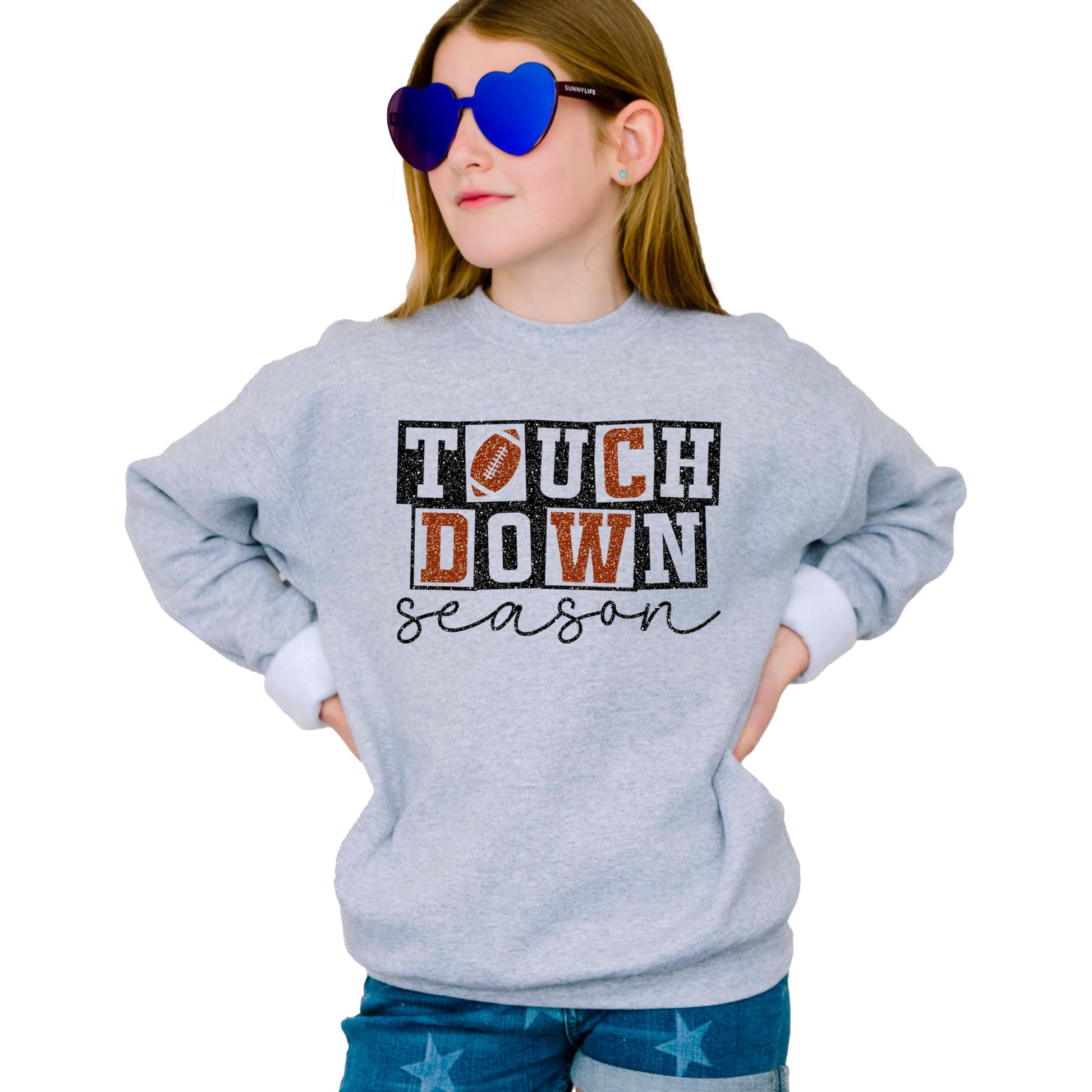 Detail shot of faux glitter football graphic on grey game day sweatshirt