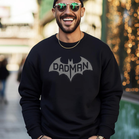 DadMan Hero sweatshirt laid flat showing full front graphic design on white fabric