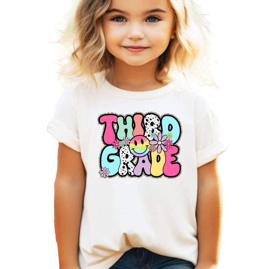 Front view of girls retro 3rd grade back to school graphic tee with printed glitter effect