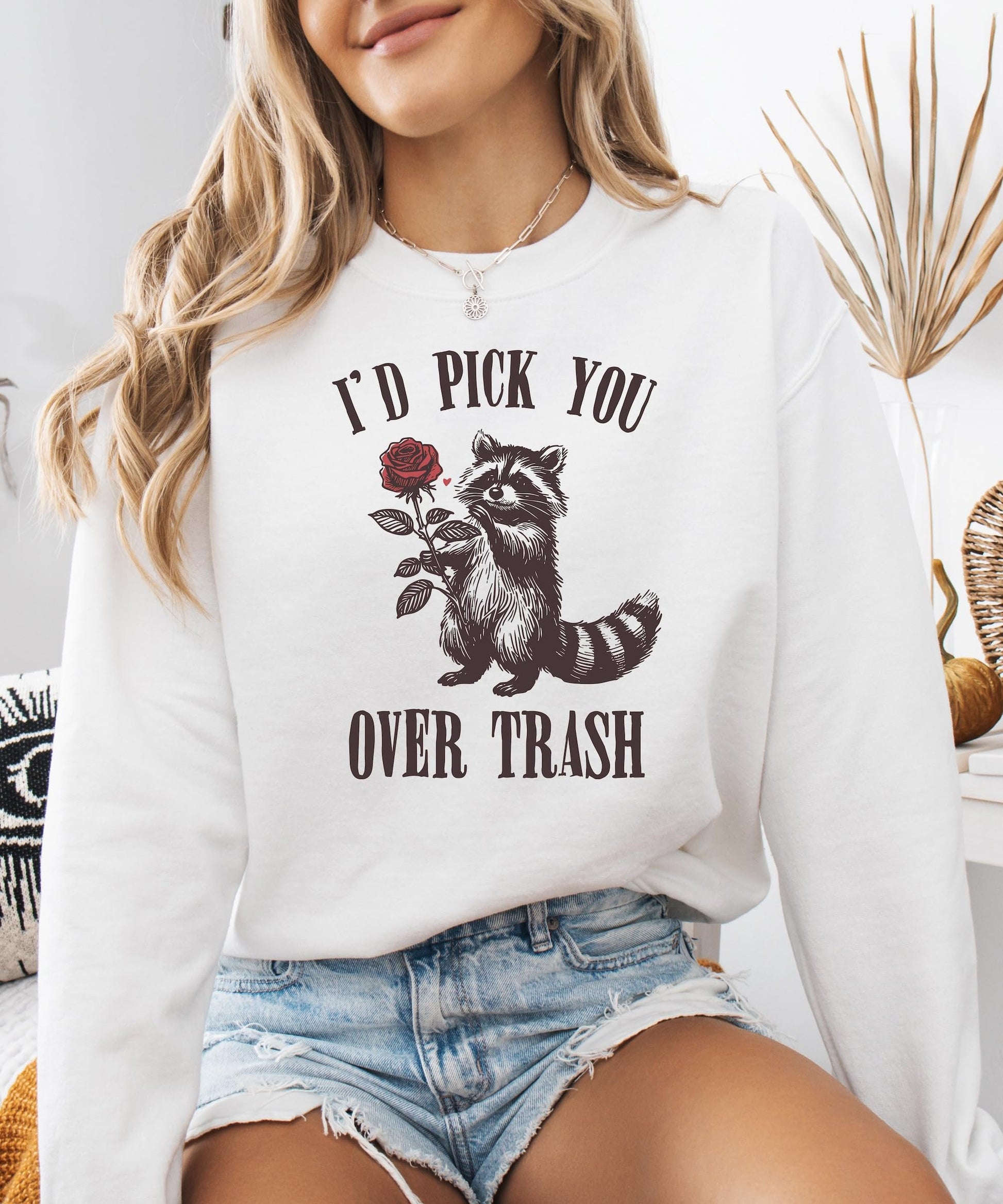 Toddler or youth size white sweatshirt featuring 'I'd Pick You Over Trash' raccoon Valentine's graphic