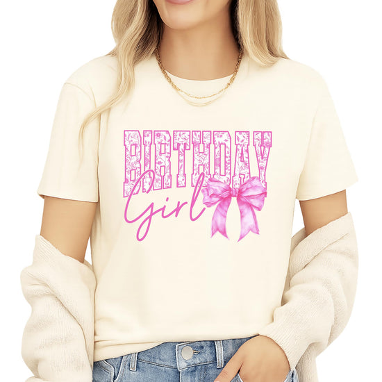 Close-up view of floral letter design and pink bow detail on birthday shirt