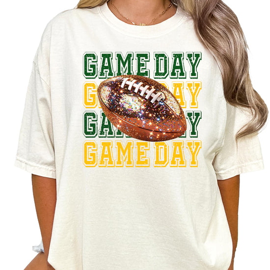 Full-length view of women's game day football tee in ivory with green and yellow design