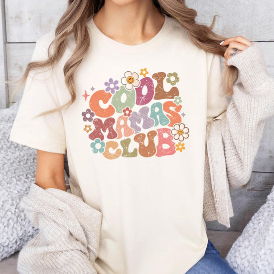 Close-up of distressed retro floral Cool Mamas Club print on natural women's tee