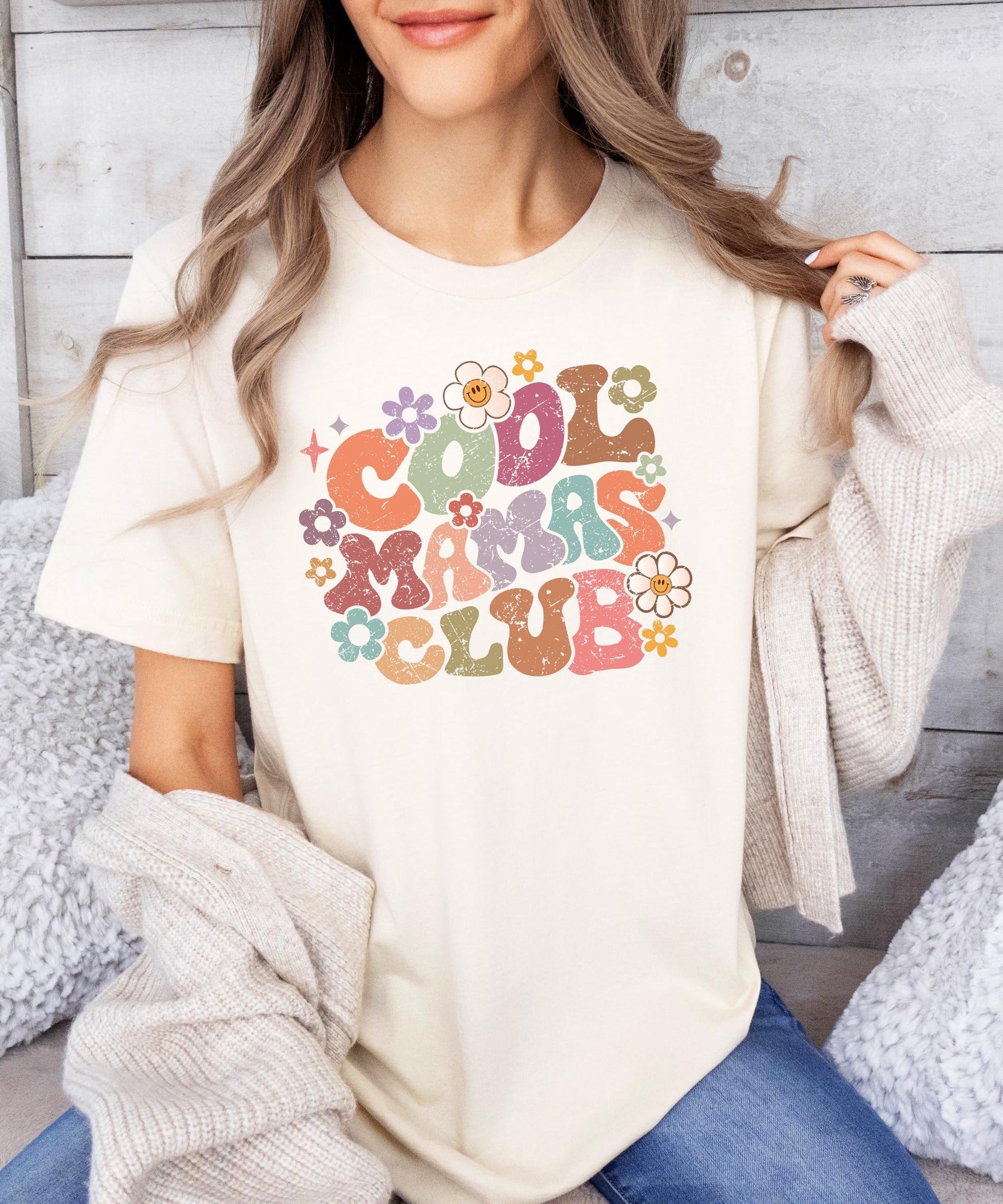 Close-up of distressed retro floral Cool Mamas Club print on natural women's tee