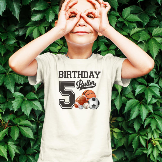 Detail shot of high-quality sports birthday graphic on black kids t-shirt