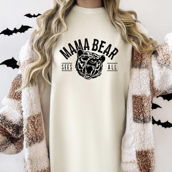 Mama Bear Sees All women's graphic tee laid flat showing full print detail