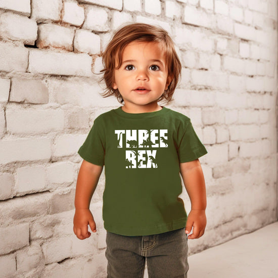 Full product view of Three Rex third birthday dinosaur shirt for toddlers, white print on military green