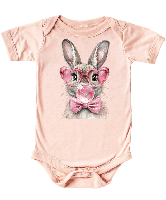 Front view of natural cotton snap-bottom baby onesie featuring cute Easter rabbit with glasses and bow graphic