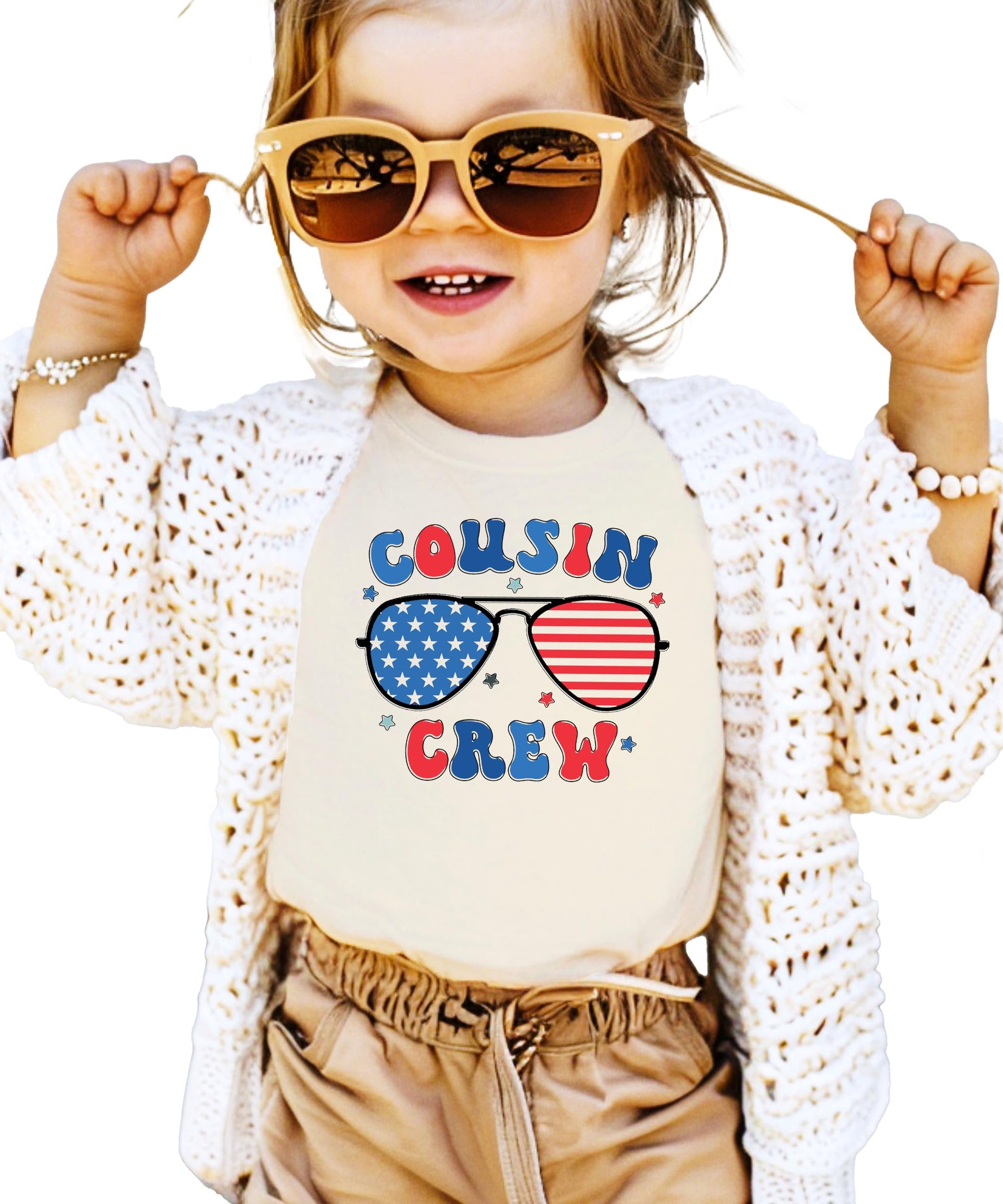 Peach colored youth t-shirt with Cousin Crew text and patriotic sunglasses design in red white and blue