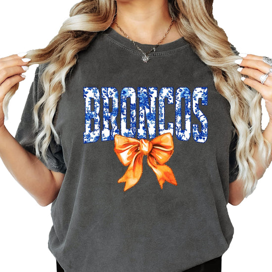 Women's Broncos orange floral bow graphic tee with blue floral lettering and orange bow accent