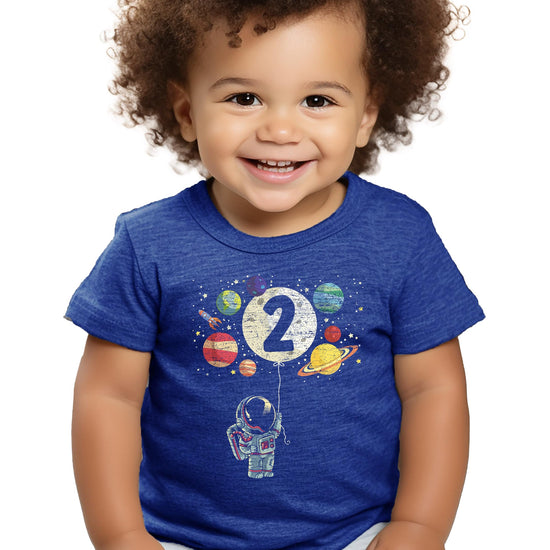 Front view of black kids space birthday shirt with rocket and planet design by Olive Loves Apple