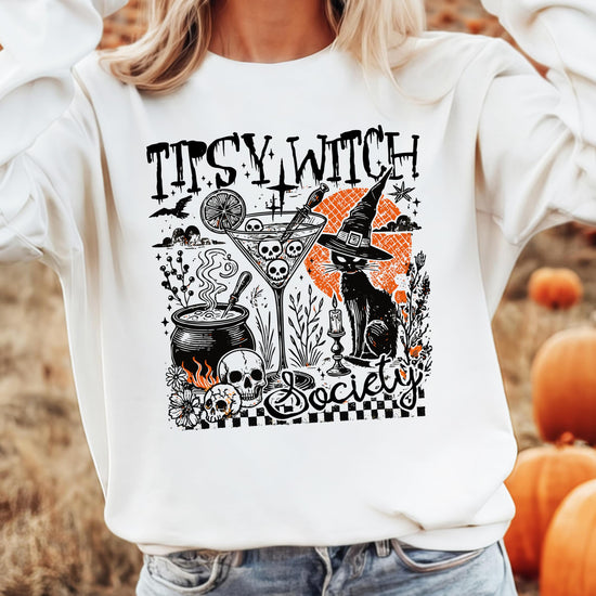 Women modeling Tipsy Witch Society Halloween sweatshirt in black with witchy cocktail graphic