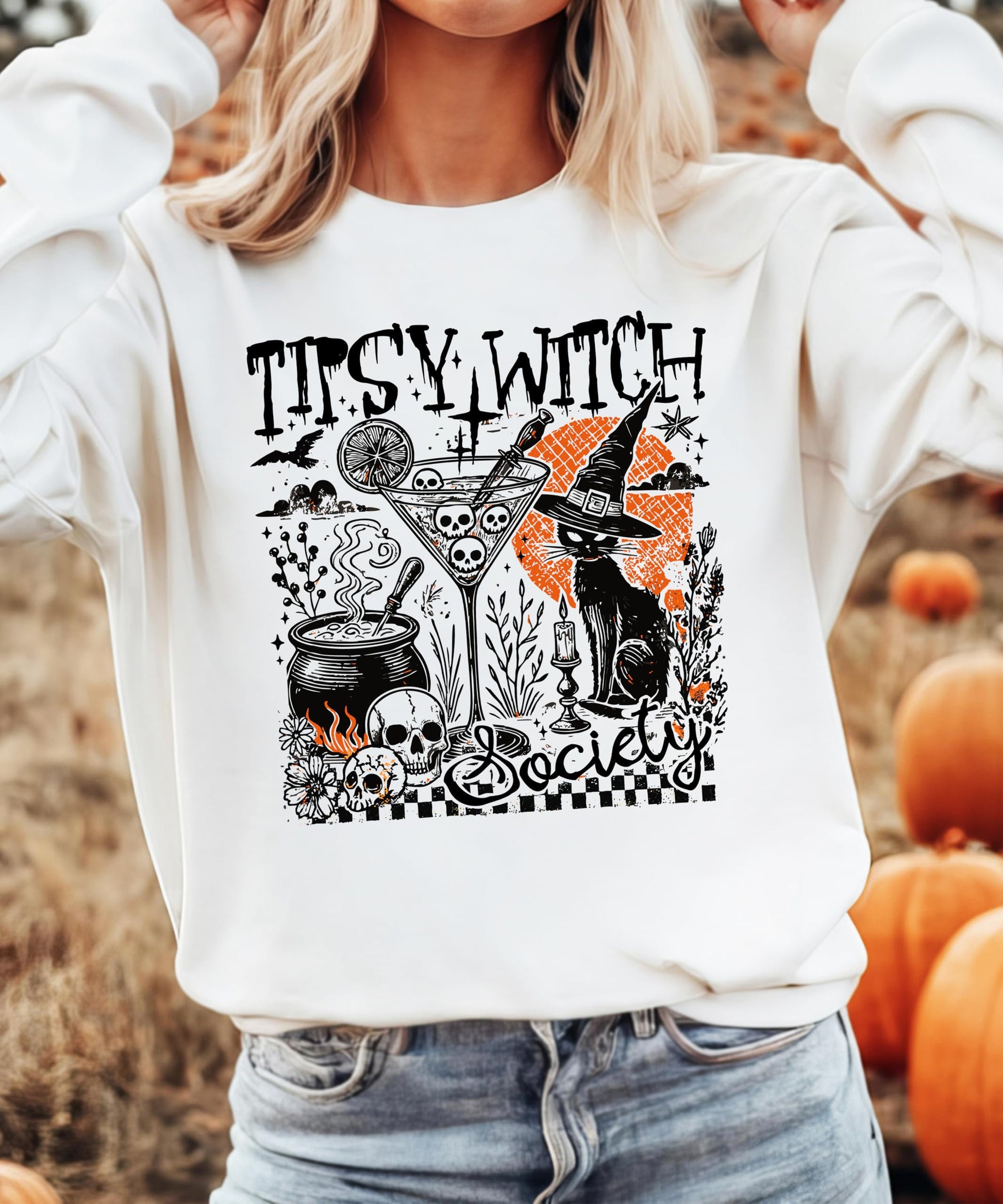 Women modeling Tipsy Witch Society Halloween sweatshirt in black with witchy cocktail graphic