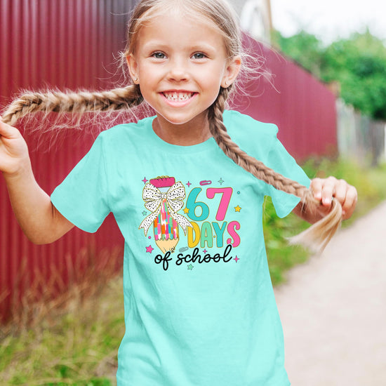 67 Days of School kids' tee laid flat showing full coquette bow pencil meme graphic