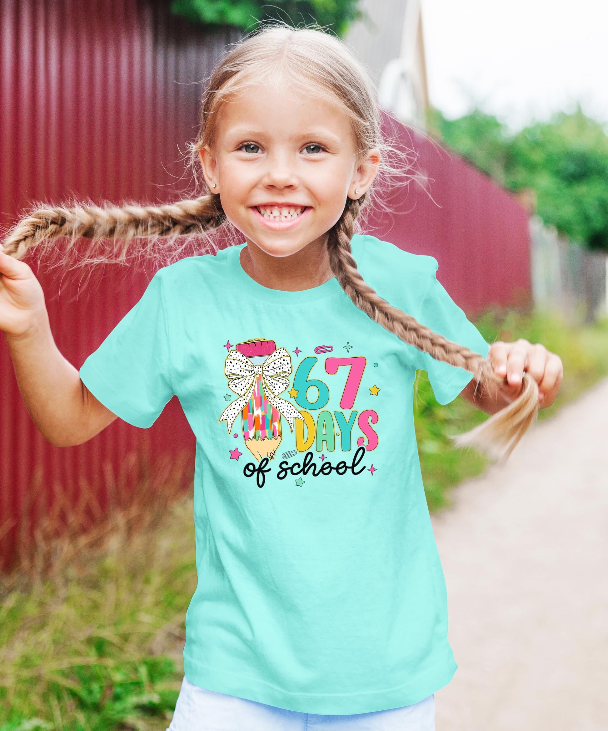 67 Days of School kids' tee laid flat showing full coquette bow pencil meme graphic
