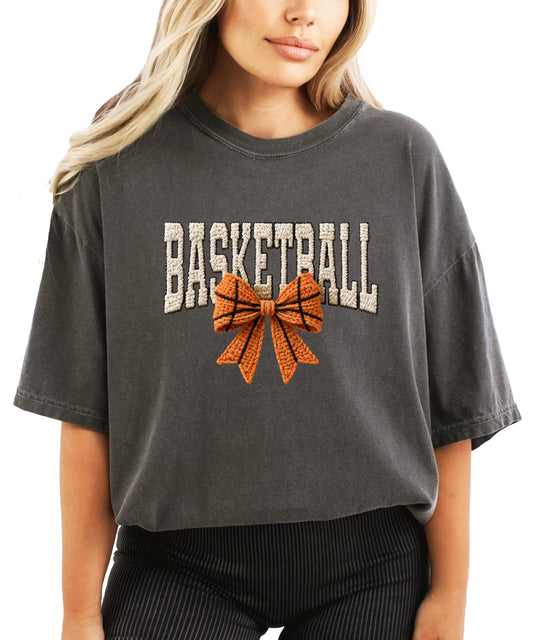 Close-up of coquette bow basketball ink-printed graphic on ivory women's shirt