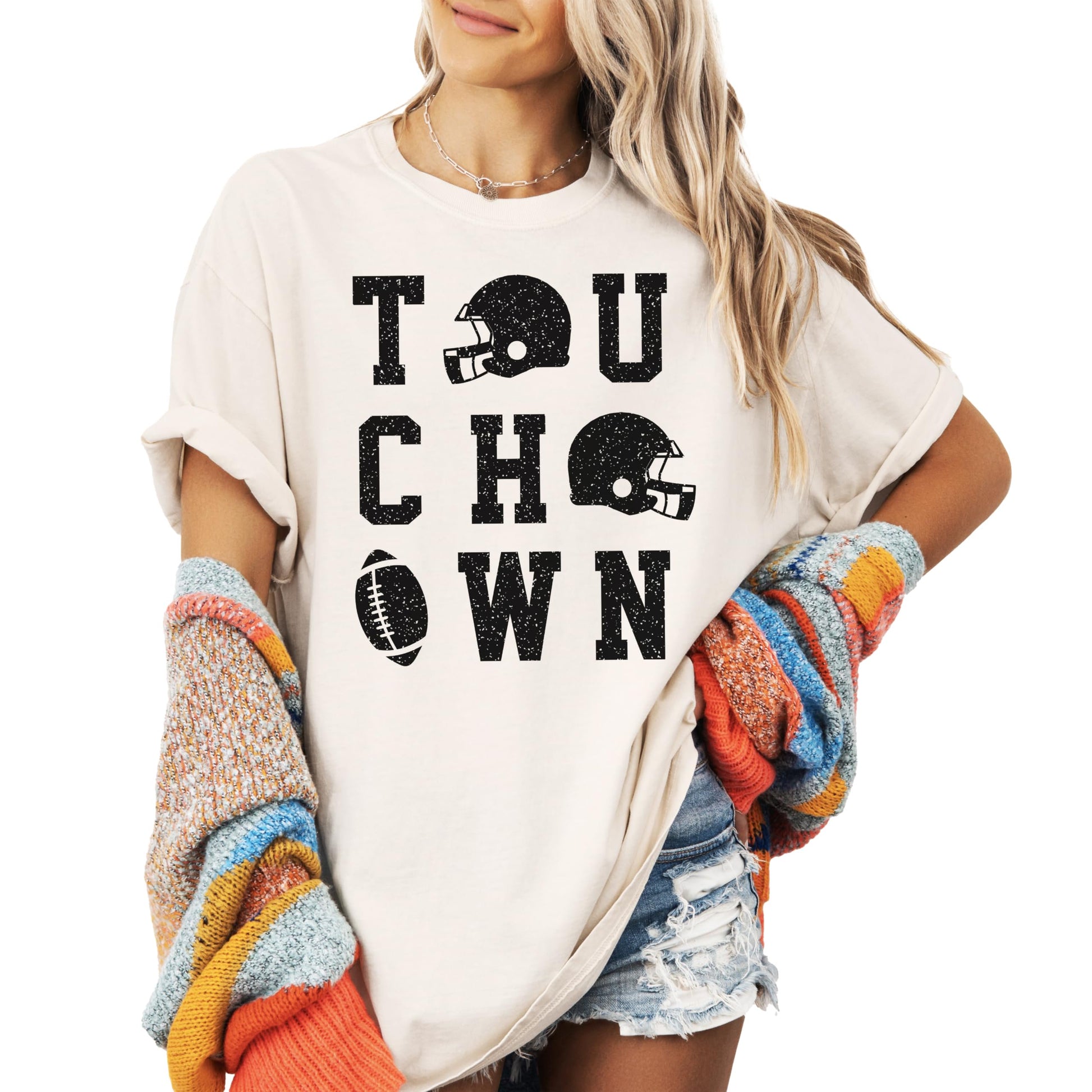 Woman wearing ivory football game day shirt with touchdown design in lifestyle setting