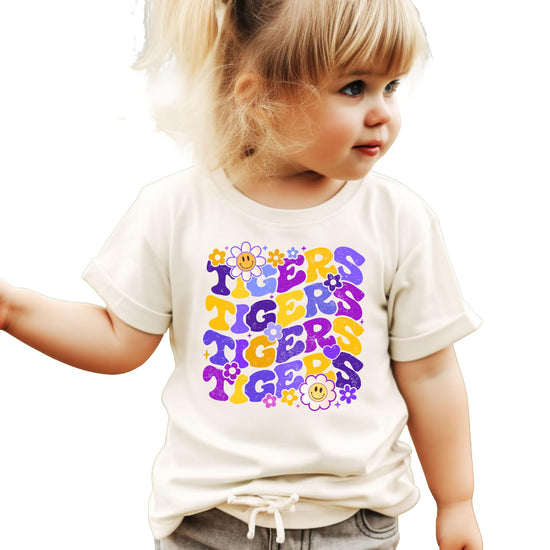 Purple Tigers team spirit graphic tee with retro font and floral design on natural colored shirt