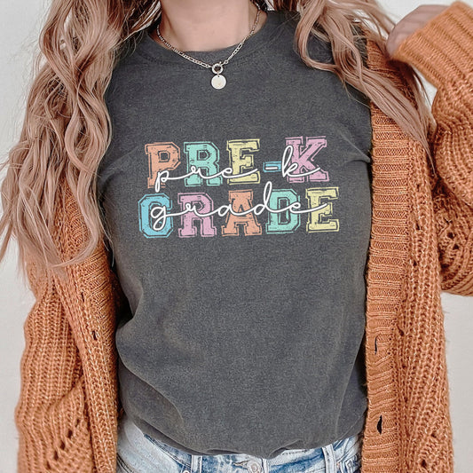 Close-up view of Pre-K Grade text featuring vibrant rainbow colored letters
