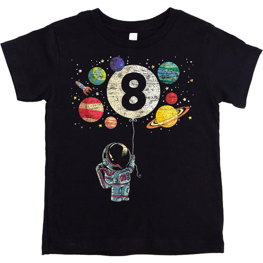 Close-up of space-themed birthday tee featuring rocket, moon balloon, and colorful planets