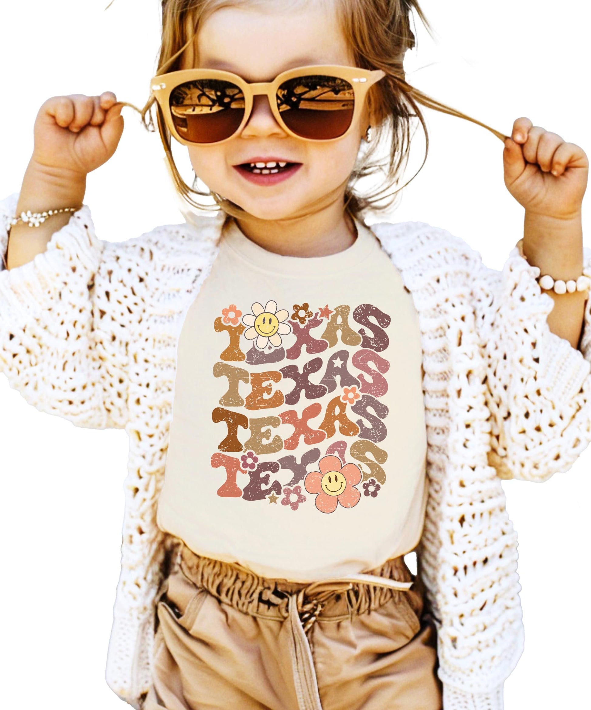 Texas shirt flat lay showing complete groovy design with multicolored letters and smiley flowers