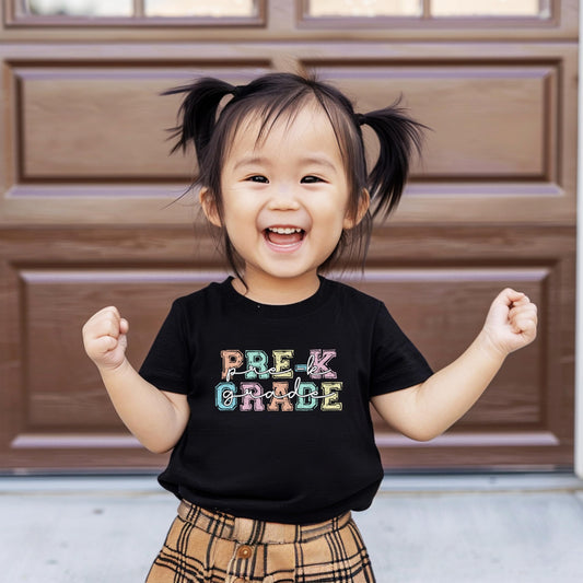 Close-up view of Pre-K Grade shirt showing pastel rainbow lettering design
