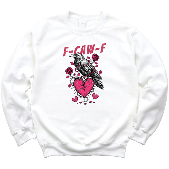 Flat lay of white Valentine's Day sweatshirt featuring crow and broken heart design