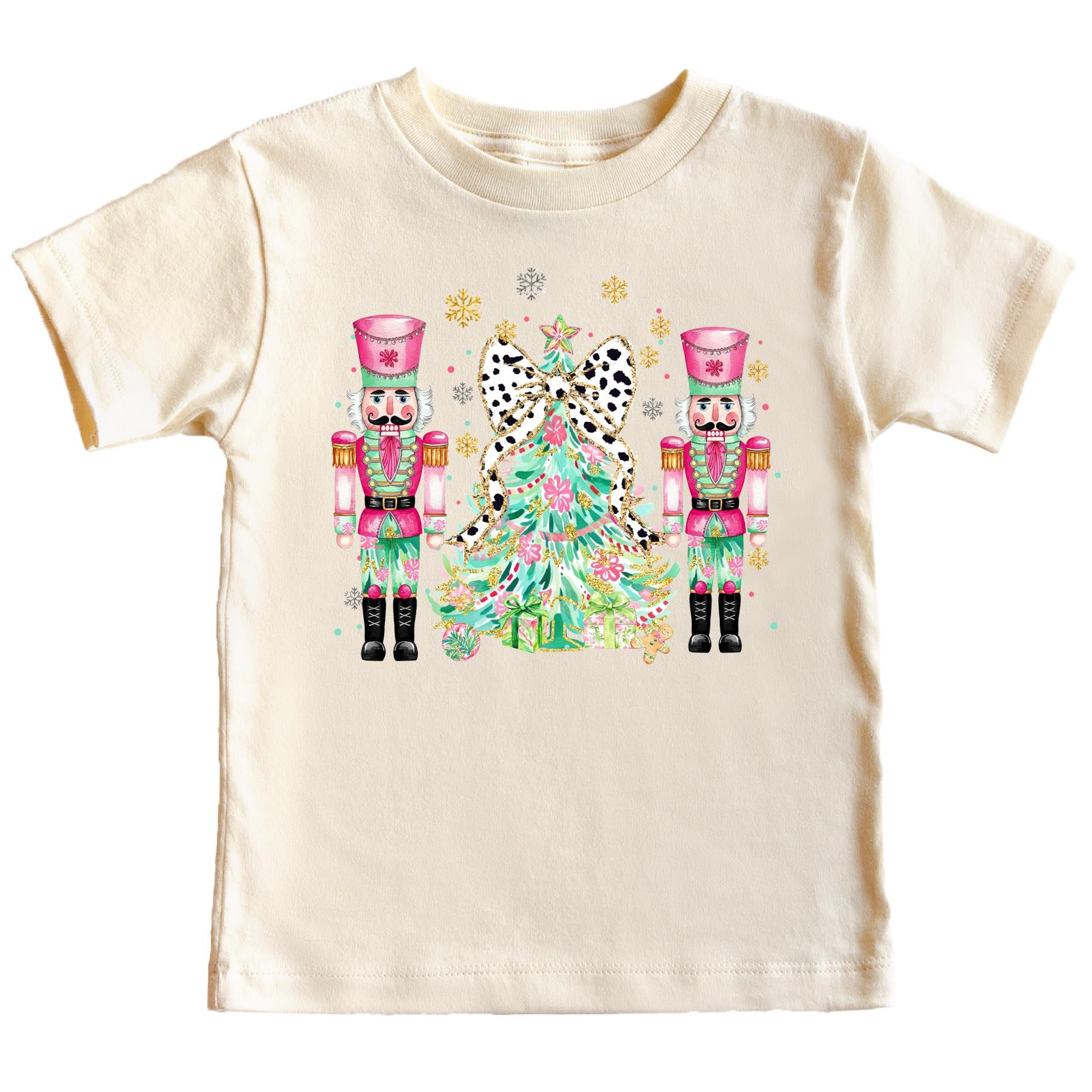 Close-up of vibrant nutcracker and Christmas tree print on a soft peach holiday shirt