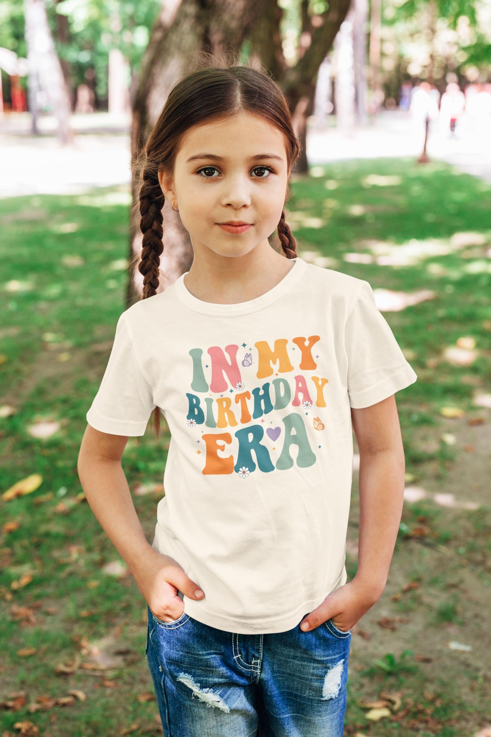 Detail shot of soft peach youth birthday shirt with trendy 'In My Birthday Era' graphic print