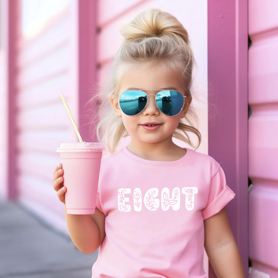 Flat lay of girls pink floral Eight birthday shirt youth sizing