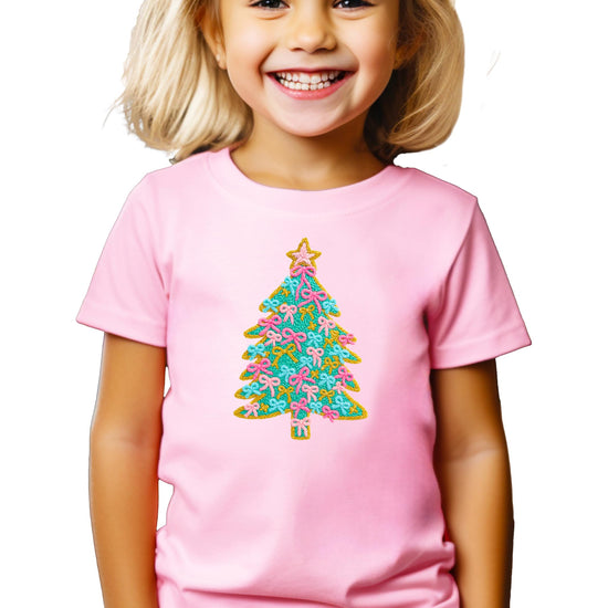 Front view of toddler Christmas tree graphic shirt with pink bows and gold star on natural fabric