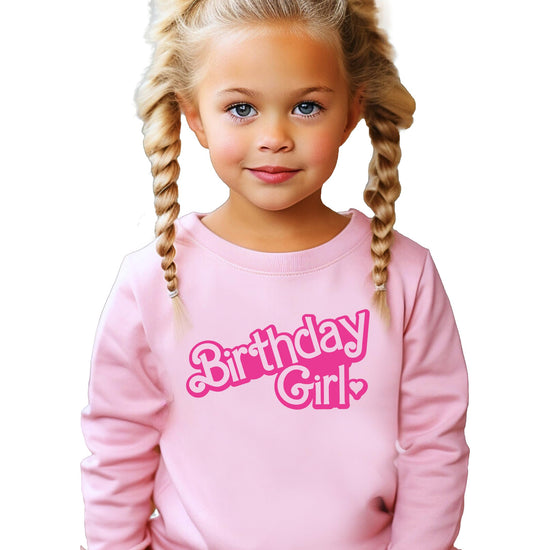 Toddler girl wearing pink Birthday Girl sweatshirt at birthday party
