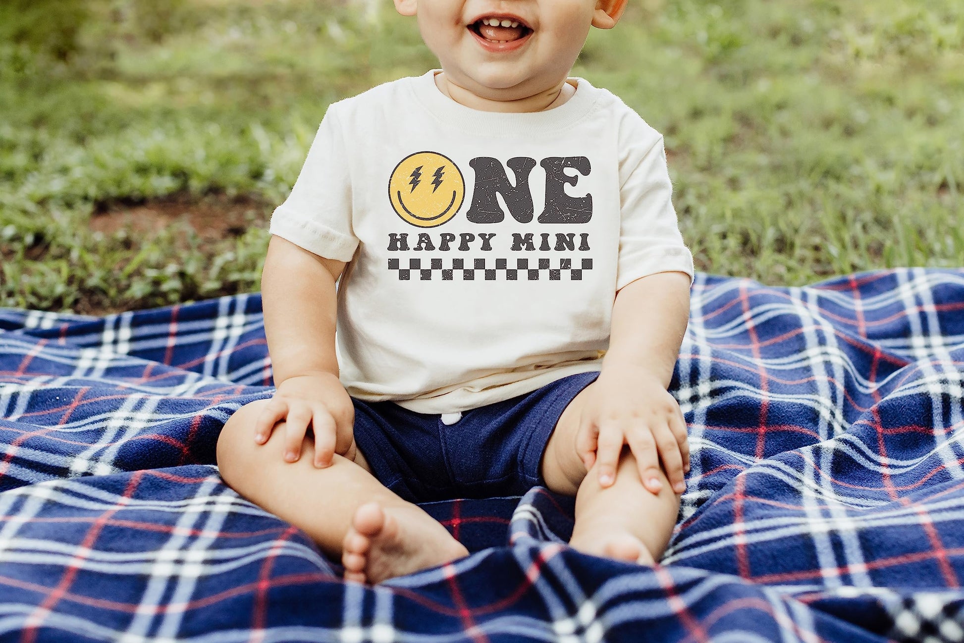 Full family wearing matching One Happy Mom Mini groovy first birthday graphic tees