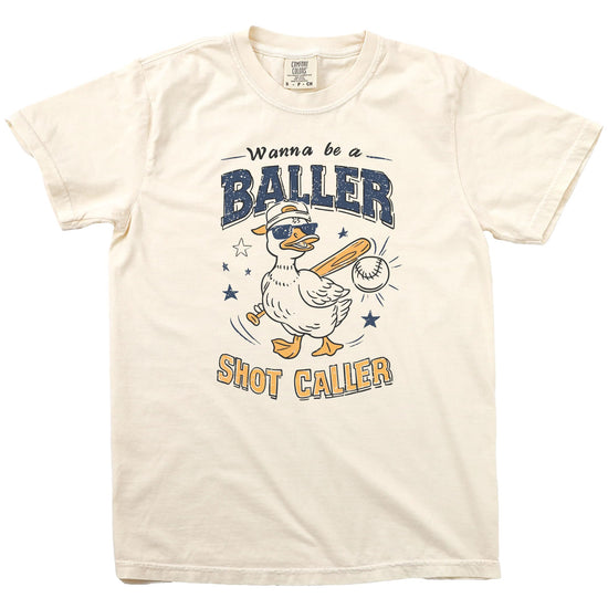 Flat lay of cream colored baseball shirt showing full duck graphic and text design