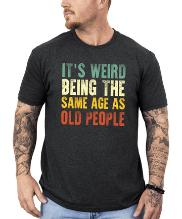 Dark gray heather men's graphic tee with funny 'It's Weird Being The Same Age As Old People' text print