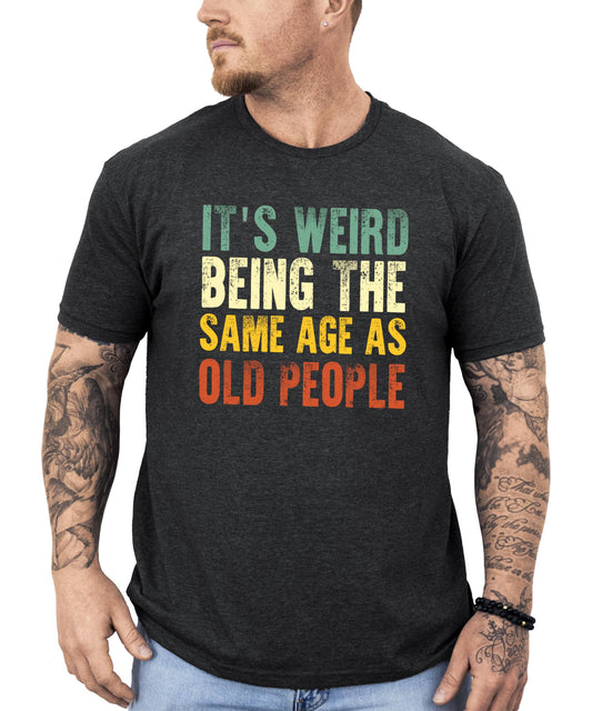 Dark gray heather men's graphic tee with funny 'It's Weird Being The Same Age As Old People' text print