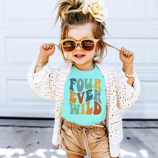 Flat lay of Four Ever Wild groovy 4th birthday shirt for toddler girls and boys