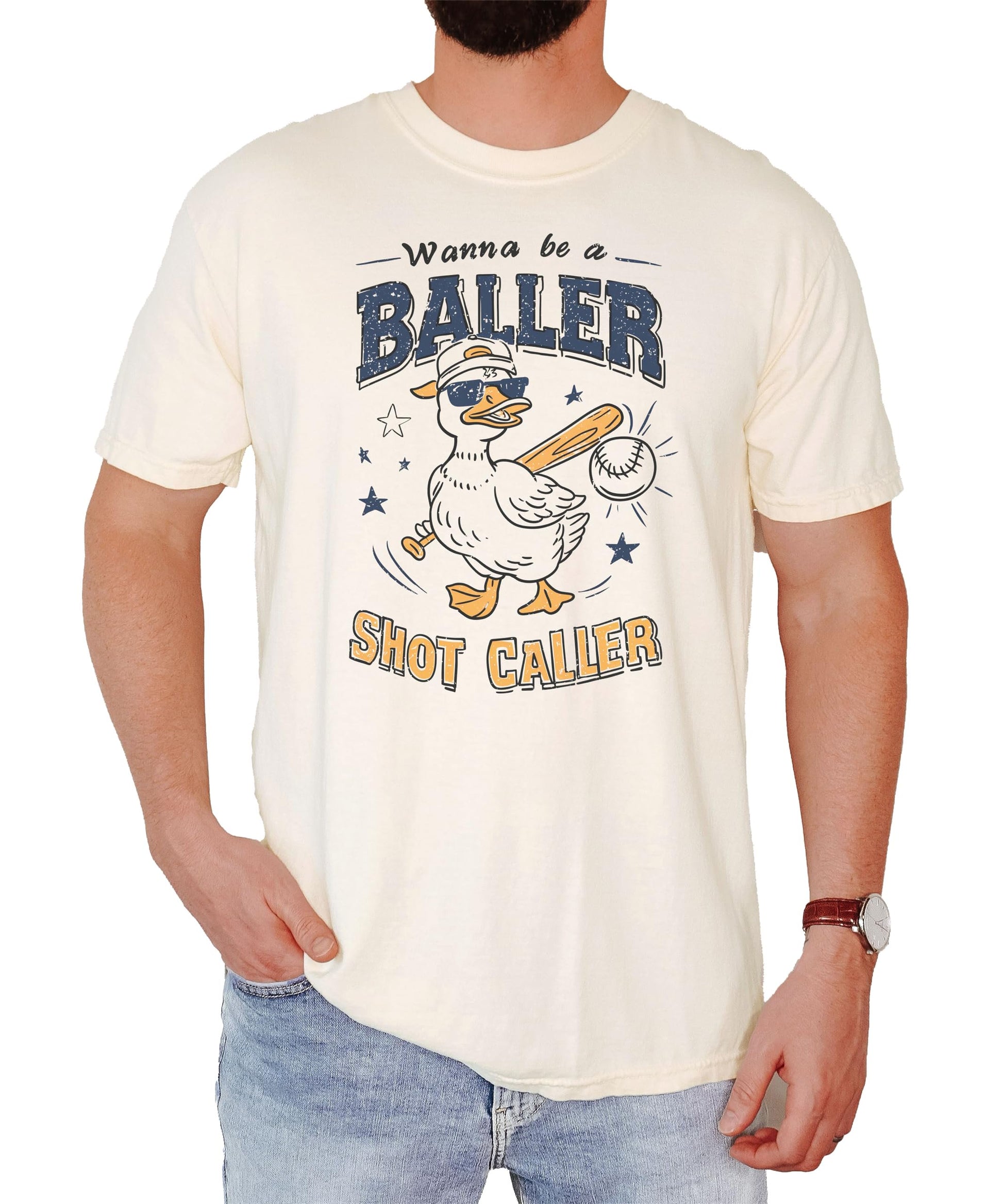 Close-up view of duck baseball graphic design on cream colored unisex t-shirt