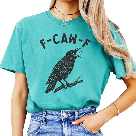 Side view of funny crow Halloween shirt in seafoam green showcasing relaxed fit on adult